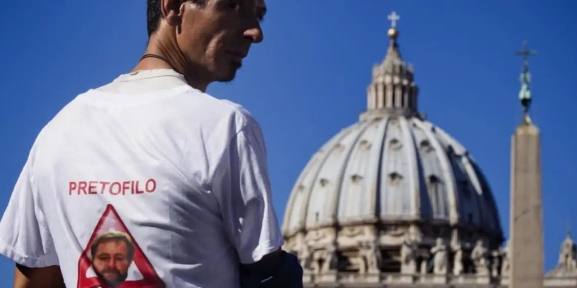 Francesco Zanardi, who claims he was sexually abused by a priest, arrives at St. Peter Square at the Vatican Tuesday, Oct. 11, 2011. Two Italians who say they were sexually abused by priests have completed a 340-mile (550-kilometer) protest march to the Vatican and demanded an independent inquiry. The journey from Savona in northern Italy to St. Peter's Square took 19 days. Francesco Zanardi and Alberto Sala arrived in Vatican City on Tuesday, where they tried unsuccessfully to obtain an audience with the pope. They handed over a letter demanding the Italian bishops' conference open the inquiry into priestly sex abuse and draft norms requiring pedophiles be defrocked "without exception." They want any bishop who leaves abusers in ministry to be removed. The jersey carries a play on the words "priest" and "pedophiles" over the writing "Keep out of the reach of children". (AP Photo/Angelo Carconi)