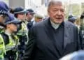 Vatican Treasurer Cardinal George Pell is surrounded by Australian police as he leaves the Melbourne Magistrates Court in Australia, October 6, 2017.    REUTERS/Mark Dadswell