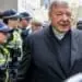 Vatican Treasurer Cardinal George Pell is surrounded by Australian police as he leaves the Melbourne Magistrates Court in Australia, October 6, 2017.    REUTERS/Mark Dadswell