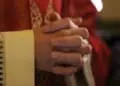 Catholic priest on altar praying during mass