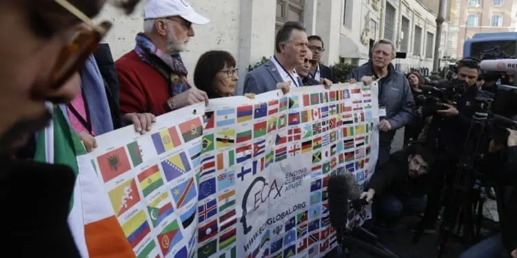 Sex abuse survivors and members of the ECA (Ending Clergy Abuse) hold their organization banner as they talk to journalists, as some of their representatives are meeting with organizers of the summit on preventing sexual abuse at the Vatican, Wednesday, Feb. 20, 2019. A dozen survivors of clergy sexual abuse met with organizers of Pope Francis' landmark summit on preventing abuse and protecting children. Chilean survivor Juan Carlos Cruz, who was asked by the Vatican to invite survivors to the meeting, told reporters Wednesday that Francis would not be attending, as had been rumored. (AP Photo/Gregorio Borgia)