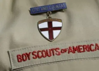 FILE - This Feb. 4, 2013 file photo shows a close up of a Boy Scout uniform badge during a news conference in front of the Boy Scouts of America headquarters in Irving, Texas. Some victims of childhood sex abuse who are considering suing the Boy Scouts of America face a choice: an anguished rush to meet a deadline earlier than what lawmakers intended, or wait and sue local councils, perhaps putting them at greater risk of losing. (AP Photo/Tony Gutierrez, File)