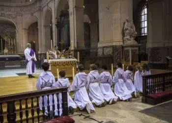 epa08850681 The Altar boys attend the mass at Saint Roch Church in Paris, France, 29 November 2020. Churches have reopened in France with a maximum capacity of 30 people after being closed since 30 October 2020, due to the second wave of the COVID-19 pandemic. EPA-EFE/CHRISTOPHE PETIT TESSON