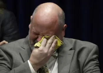 Former priest James Faluszczak, who says he was molested as a teenager by a priest, reacts as Pennsylvania Attorney General Josh Shapiro speaks during a news conference at the Pennsylvania Capitol in Harrisburg on Tuesday.