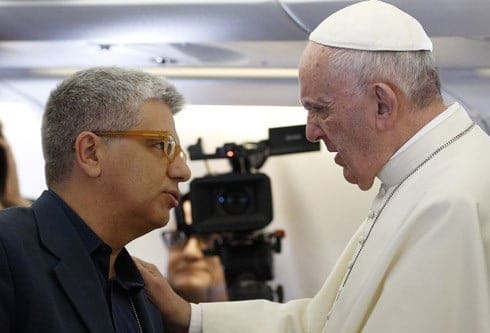 Pope Francis speaks with Italian journalist Andrea Tornielli aboard his flight from Rome to Havana in this Sept. 19, 2015, file photo. Tornielli conducted an interview with the pope on the topic of mercy. The interview is contained in a new book titled, "The Name of God Is Mercy." (CNS photo/Paul Haring) See POPE-MERCY-INTERVIEW Jan. 11, 2016.