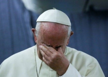 Pope Francis gestures during a news conference on board of the plane during his flight back from a trip to Chile and Peru, January 22, 2018. REUTERS/Alessandro Bianchi