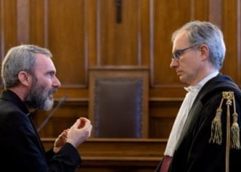Father Carlo Alberto Capella, a Catholic priest sentenced to five years in jail for possessing child pornography, talks with his lawyer during a trial at the Vatican June 23, 2018. Vatican Media/Handout via REUTERS  ATTENTION EDITORS - THIS IMAGE WAS PROVIDED BY A THIRD PARTY     TPX IMAGES OF THE DAY