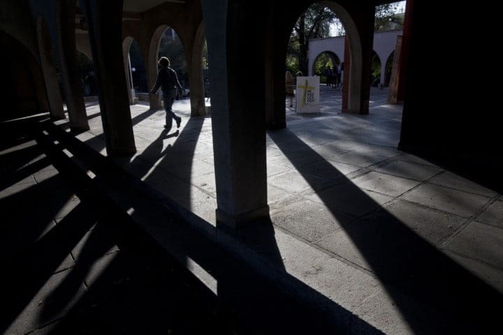 A woman walks outside the El Bosque Parish in Santiago, Chile, Thursday, March 28, 2019. The Parish was where Rev. Fernando Karadima, who was accused of sexual abuse, used to reside and work. (AP Photo/Esteban Félix)
