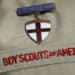 FILE - This Feb. 4, 2013 file photo shows a close up of a Boy Scout uniform badge during a news conference in front of the Boy Scouts of America headquarters in Irving, Texas. Some victims of childhood sex abuse who are considering suing the Boy Scouts of America face a choice: an anguished rush to meet a deadline earlier than what lawmakers intended, or wait and sue local councils, perhaps putting them at greater risk of losing. (AP Photo/Tony Gutierrez, File)