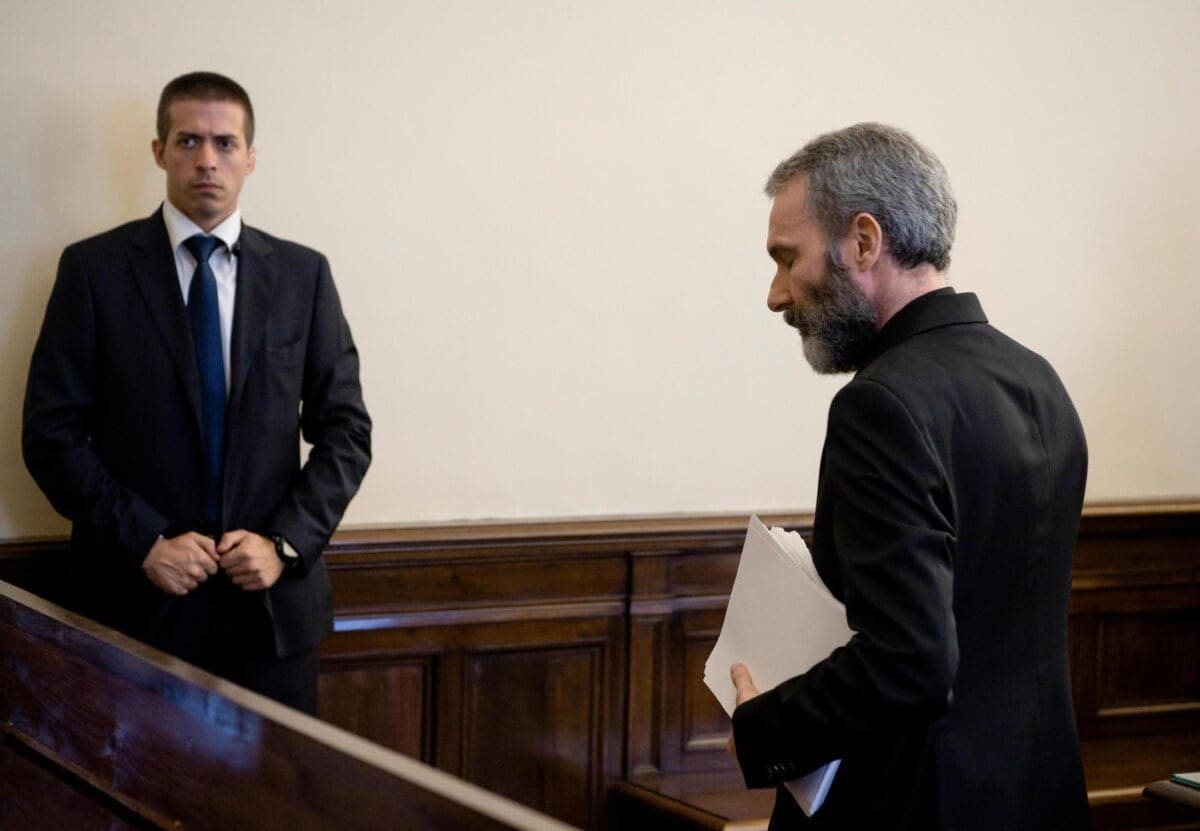Former Holy See diplomat Monsignor Carlo Alberto Capella, right, walks inside a Vatican tribunal courtroom during his trial, at the Vatican, Saturday, June 23, 2018. The Vatican tribunal on Saturday convicted Capella and sentenced him to five years in prison for possessing and distributing child pornography in the first such trial of its kind inside the Vatican. (Vatican Media/ANSA via AP)